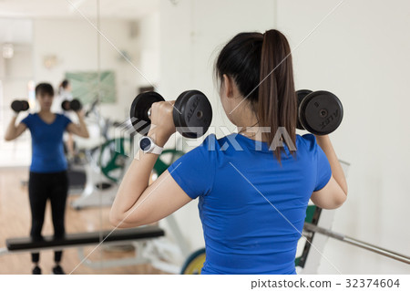 woman fitness  workout use dumbbell in on traini 32374604