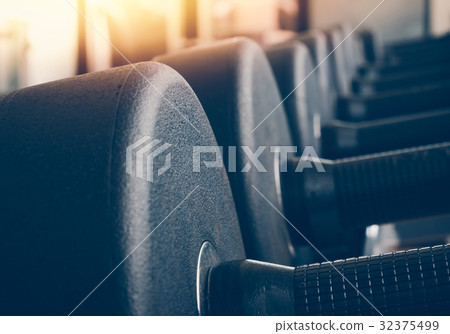 Rows of dumbbells in the gym with hign contrast  32375499