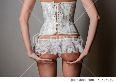 Sexy young girl in a white corset and panties Sexy young girl in a white corset and panties 32376059