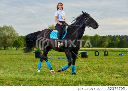 Pretty little girl riding a horse 32376705