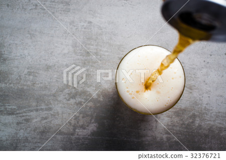 Beer pouring out of a can into a glass Beer pouring out of a can into a glass 32376721