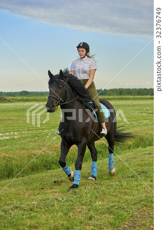Pretty little girl riding a horse 32376749