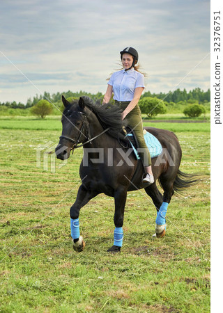 Pretty little girl riding a horse 32376751