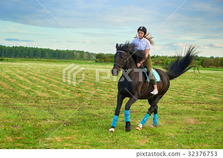 Pretty little girl riding a horse 32376753