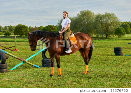 Pretty little girl riding a horse 32376760