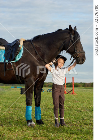 Little girl communicating with her horse 32376780