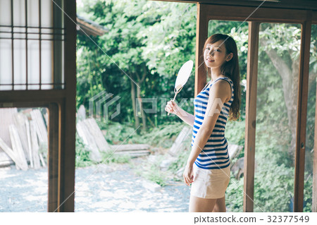 A woman caressing a fan at the edge 32377549