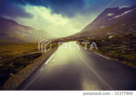Driving a car on mountain road 32377900