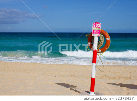 Swimming circle. Life buoy red color on beach with Swimming circle. Life buoy red color on beach with 32378437