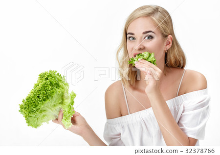 Beautiful blond woman in white blouse eating fresh 32378766