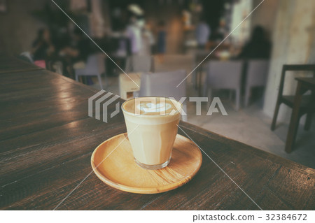cup of piccolo latte with wooden saucer cup of piccolo latte with wooden saucer 32384672