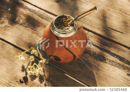 Artistic shot of Argentinean yerba mate drink in Calabash with B 32385488