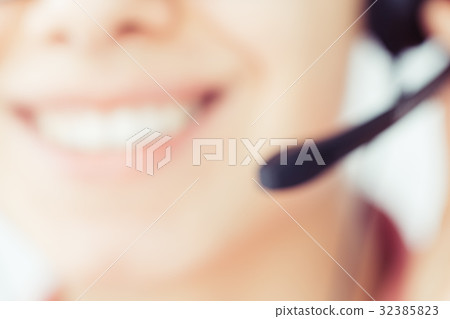 Smiling girl in the headset is working in the 32385823