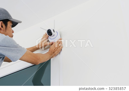 Technicians are installing a wireless cctv camera Technicians are installing a wireless cctv camera 32385857
