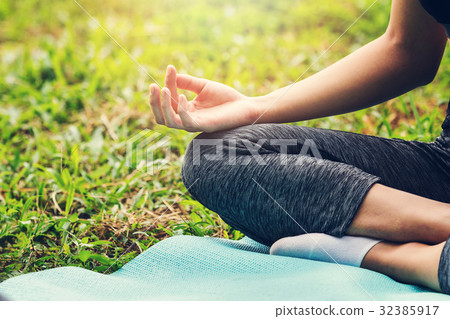 Close up of young girl doing yoga (lotus pose) 32385917