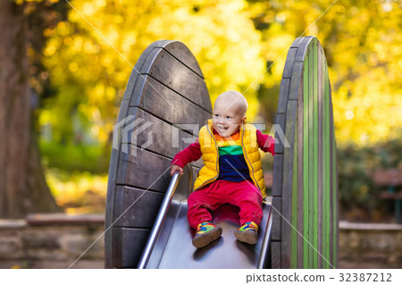 Child on playground in autumn. Kids in fall. 32387212