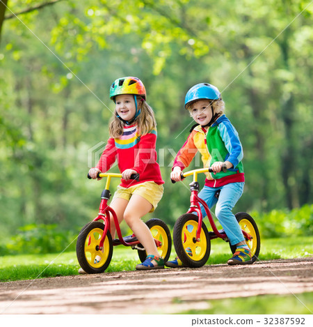 kids riding balance bikes