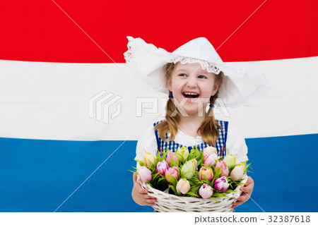 Dutch child with tulip flower and Netherlands flag Dutch child with tulip flower and Netherlands flag 32387618