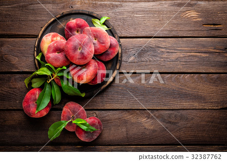 Peach, saturn or donut peaches with leaves Peach, saturn or donut peaches with leaves 32387762