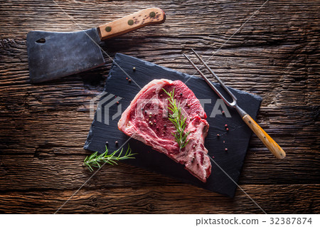 Raw fresh T-bone steak with salt pepper rosemary Raw fresh T-bone steak with salt pepper rosemary 32387874