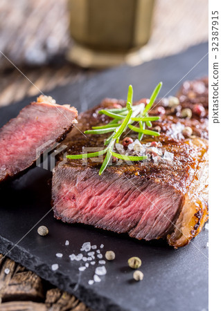 Grill juicy beef steak with salt pepper rosemary 32387915
