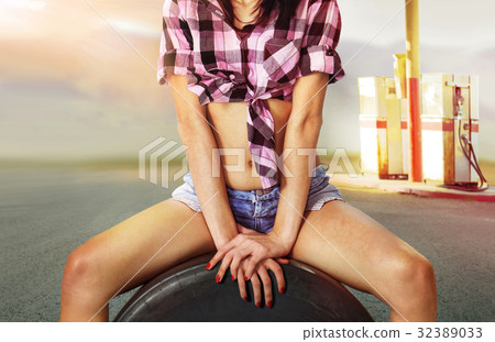 part of  woman near gas station 32389033