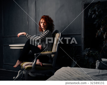 Ginger girl sitting at home 32389131