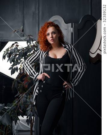 Ginger girl at home next to the mirror Ginger girl at home next to the mirror 32389132