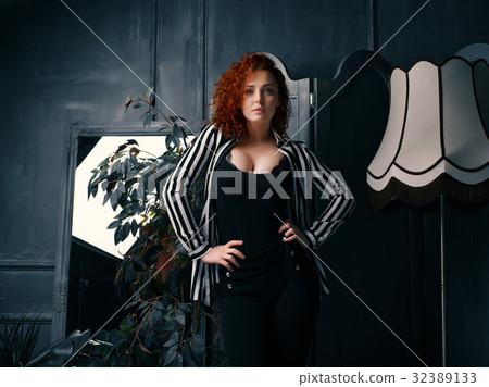 Ginger girl at home next to the mirror 32389133