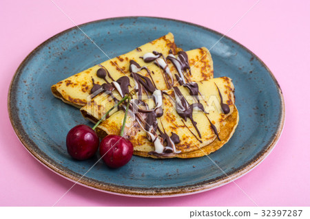 Sweet pancakes with chocolate topping on pastel Sweet pancakes with chocolate topping on pastel 32397287