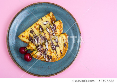 Sweet pancakes with chocolate topping on pastel 32397288