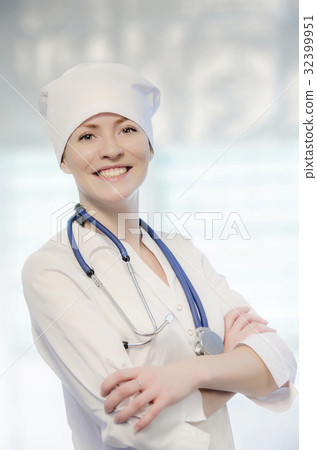 Medical doctor portrait in white coat and cap 32399951