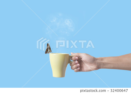hand holding green coffee cup with butterfly 32400647