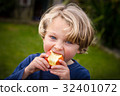 cute 5 year old child eating an apple 32401072
