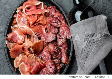 Spanish ham serrano, salami and bottle of red wine Spanish ham serrano, salami and bottle of red wine 32408497