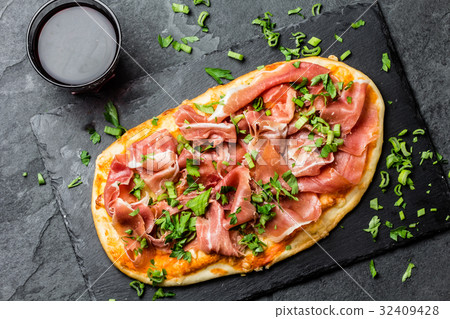 Naan pizza with ham serrano on slate board 32409428