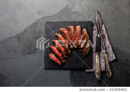 Medium rare beef steak on slate board, vintage 32409463