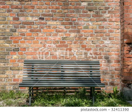 empty wooden bench with vintage brick wall empty wooden bench with vintage brick wall 32411390