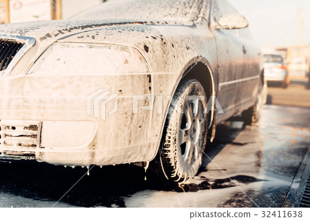 Wet vehicle in foam, automobile in suds, car wash 32411638
