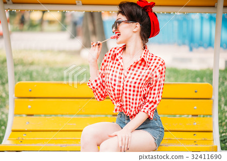 Sexy pinup girl licks sweet lollipop Sexy pinup girl licks sweet lollipop 32411690