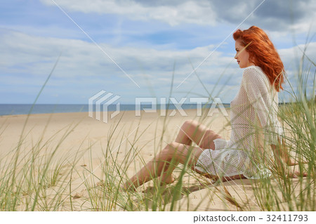 Beautiful young woman at the beach Beautiful young woman at the beach 32411793