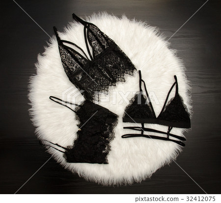 Fashion concept, three lace bustier on a white fur Fashion concept, three lace bustier on a white fur 32412075