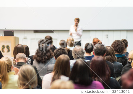 Woman giving presentation in lecture hall at Woman giving presentation in lecture hall at 32413041