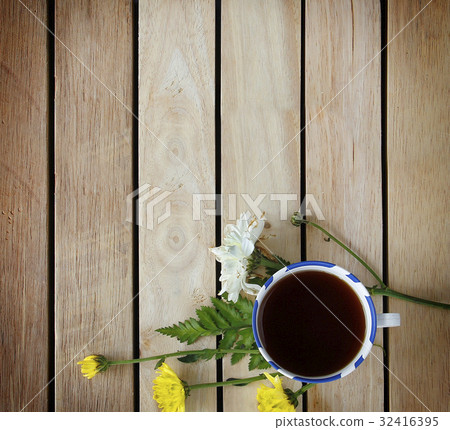 A cup of tea with flowers and tea around it A cup of tea with flowers and tea around it 32416395
