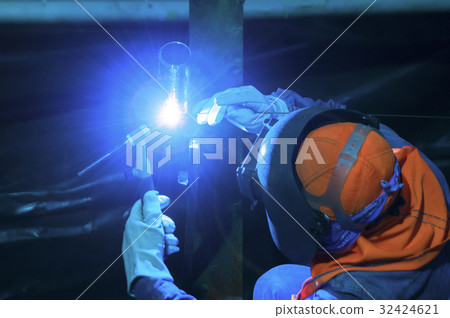Worker welding metal piping using tig welder 32424621