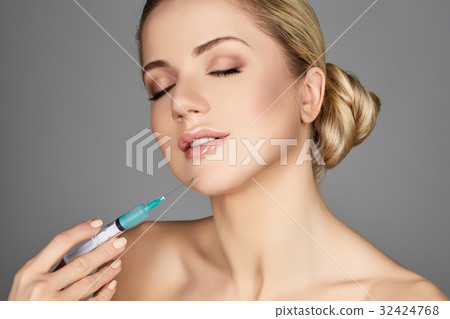beautiful girl holding syringe beautiful girl holding syringe 32424768