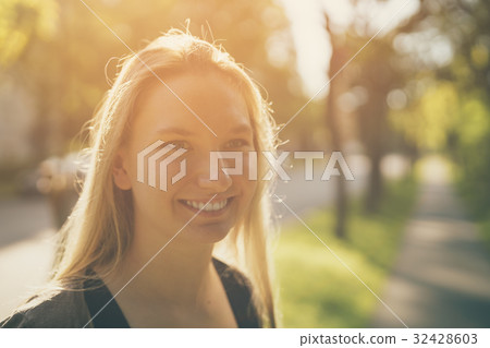 teen girl smiling in green town in sunny summer teen girl smiling in green town in sunny summer 32428603