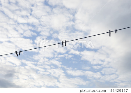 Blue clothesline over cloudy sky 32429157