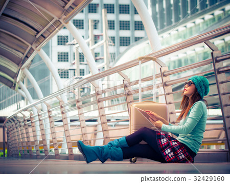 Woman traveler sitdown on the floor in airport Woman traveler sitdown on the floor in airport 32429160