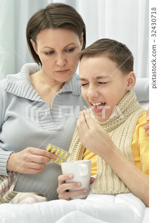 Mother taking care of son 32430718